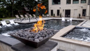 Custom pool installation with a fire pit nearby